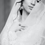 woman in white wedding dress closing eyes