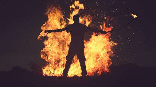 person standing in front of fire during night time