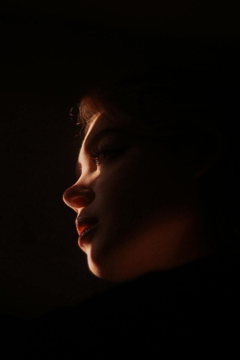 Womans Face in Darkness