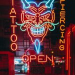 red and blue tattoo piercing open LED sign